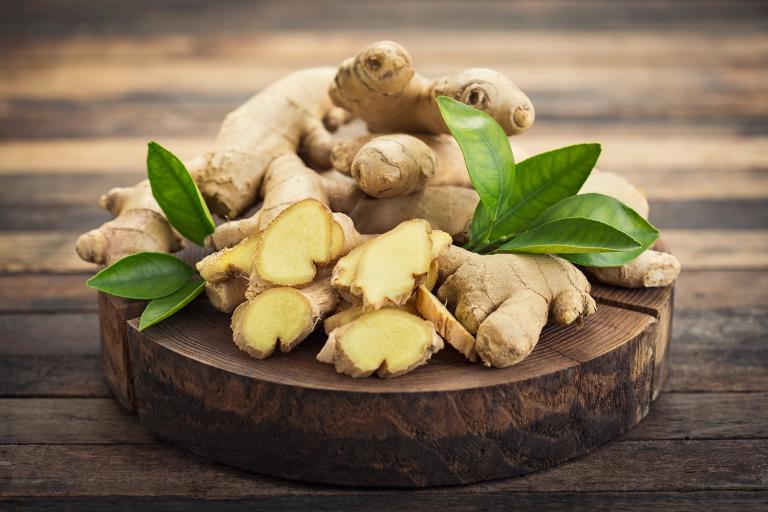 a platter of sliced and whole ginger root